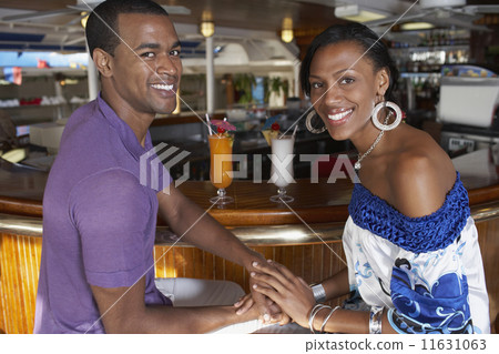 Multi-ethnic couple at bar 11631063