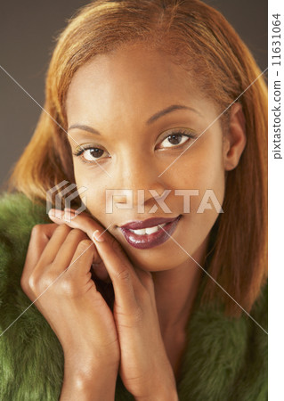 African woman resting chin on hands African woman resting chin on hands 11631064