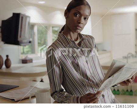 African American woman holding newspaper 11631109