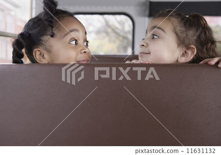 Profile of girls on school bus 11631132