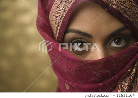 Middle Eastern woman wearing face covering 11631164