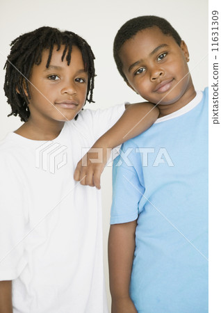 African boy leaning on brother's shoulder 11631309