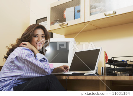 Hispanic woman in home office Hispanic woman in home office 11631394