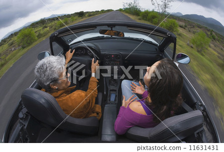 Mother and adult daughter in convertible car 11631431
