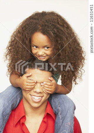African father carrying daughter on shoulders 11631451