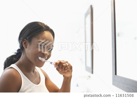 African American woman brushing teeth African American woman brushing teeth 11631508