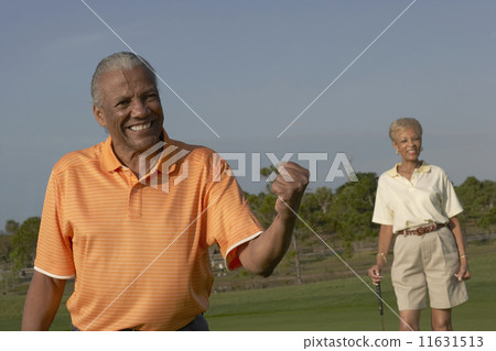 Senior African American couple on golf course Senior African American couple on golf course 11631513