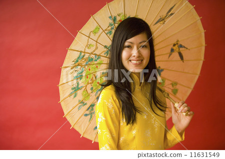 Asian woman holding parasol 11631549