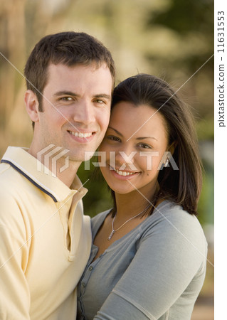 Hispanic couple hugging 11631553