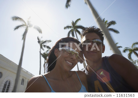 Multi-ethnic couple wearing sunglasses Multi-ethnic couple wearing sunglasses 11631563