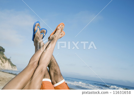 Multi-ethnic couple with feet in air 11631658