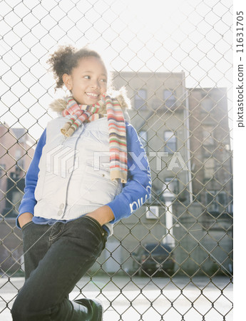 African girl leaning against fence African girl leaning against fence 11631705
