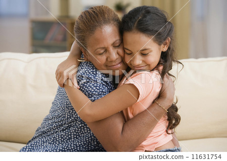 Mother and daughter hugging Mother and daughter hugging 11631754