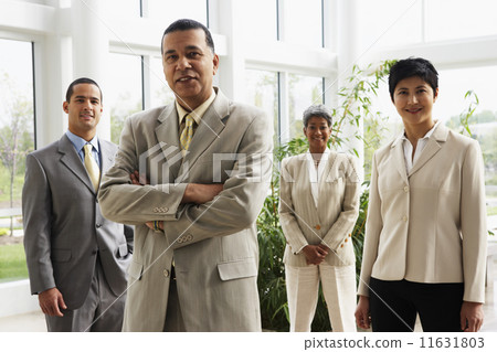 Businessman with coworkers in background Businessman with coworkers in background 11631803