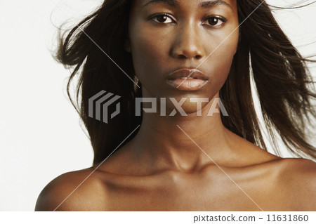 African woman with bare shoulders and hair blowing 11631860