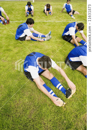 Multi-ethnic male soccer players stretching Multi-ethnic male soccer players stretching 11631873