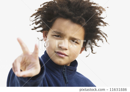 Close up of a boy making the peace sign Close up of a boy making the peace sign 11631886
