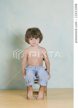 Hispanic boy sitting in chair 11631896