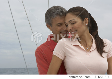 Multi-ethnic couple hugging Multi-ethnic couple hugging 11631905