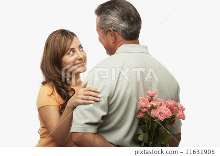 Hispanic man surprising wife with flowers Hispanic man surprising wife with flowers 11631908
