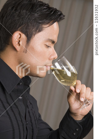 Hispanic man drinking wine Hispanic man drinking wine 11631932