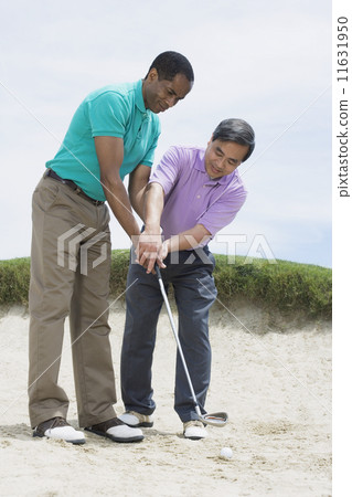 Multi-ethnic men playing golf 11631950