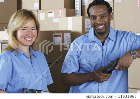 Male and female warehouse workers in warehouse 11631963
