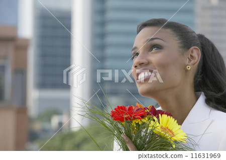 African businesswoman holding flowers 11631969