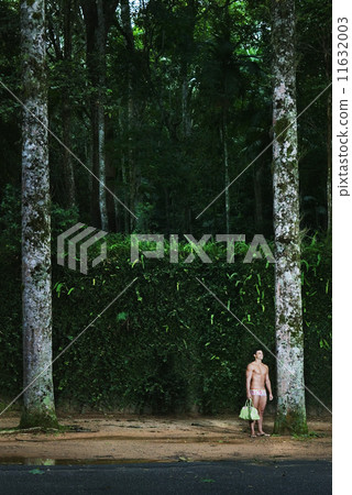 Hispanic man wearing bathing suit in woods Hispanic man wearing bathing suit in woods 11632003