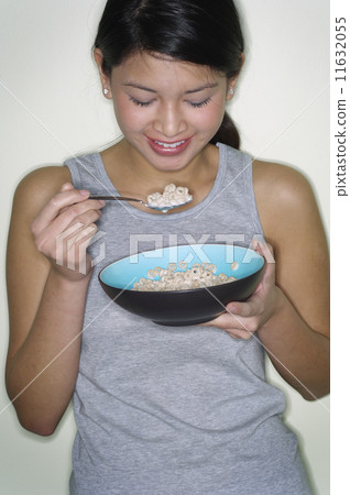 Portrait of Asian woman eating cereal 11632055