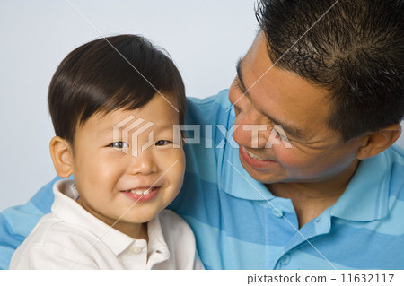 Asian father smiling at son 11632117