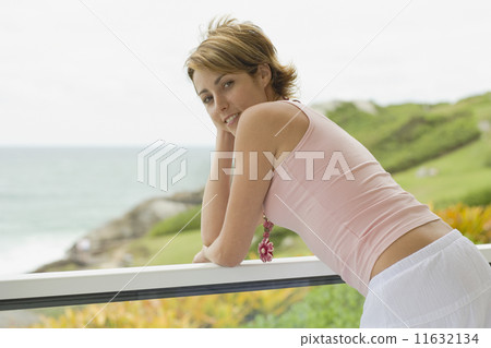 Young woman leaning on railing Young woman leaning on railing 11632134