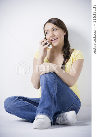 Hispanic woman talking on cell phone Hispanic woman talking on cell phone 11632135