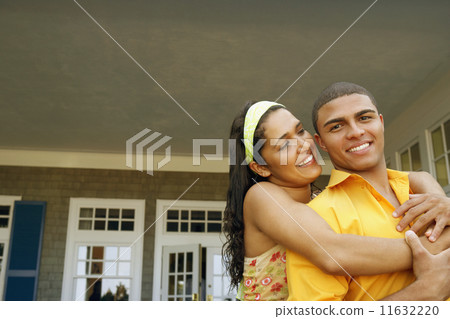 Hispanic couple hugging outdoors Hispanic couple hugging outdoors 11632220