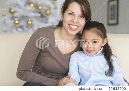 Hispanic mother and daughter hugging Hispanic mother and daughter hugging 11632290