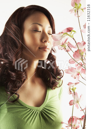 Asian woman smelling flowers 11632316