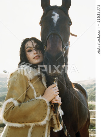 Young woman leading a horse 11632372