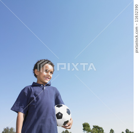 Young boy holding a soccer ball 11632390