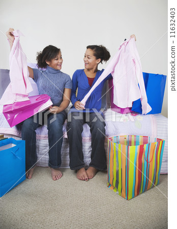 African twin sisters comparing purchases 11632403