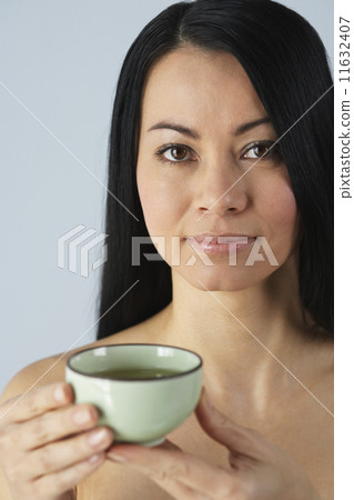 Asian woman holding tea cup 11632407