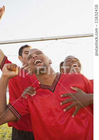 Teammates cheering and hugging 11632416