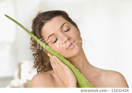 Woman hugging aloe leaf 11632426