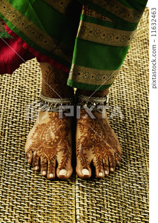 Feet with tattoos and anklets 11632463