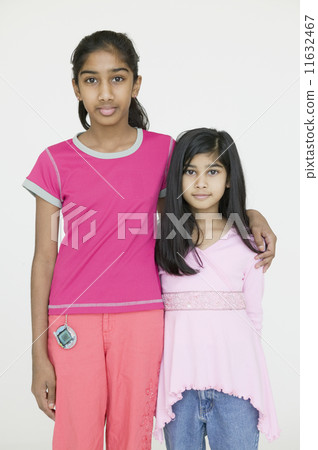Two Indian sisters hugging 11632467