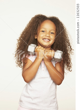 Portrait of African girl holding dumbbell Portrait of African girl holding dumbbell 11632503