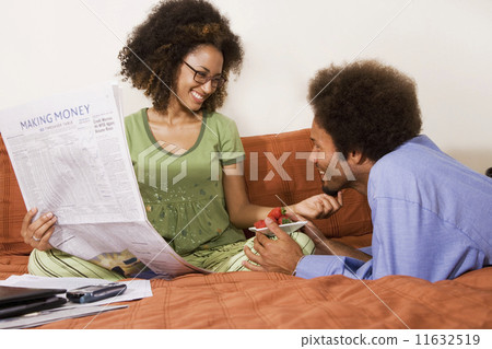 African man bringing strawberries to wife in bed 11632519