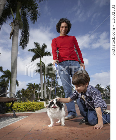 Hispanic father and son with dog 11632533