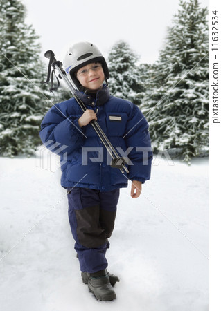 Mixed Race boy holding ski poles Mixed Race boy holding ski poles 11632534
