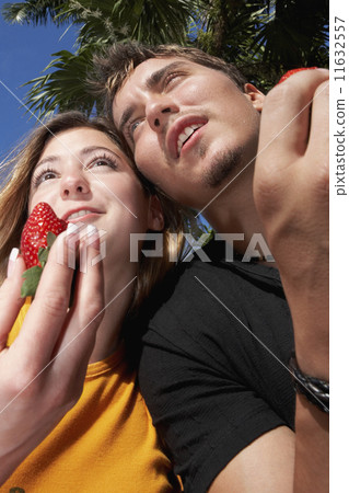 Young couple holding strawberries 11632557