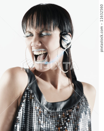 Pacific Islander woman listening to headphones Pacific Islander woman listening to headphones 11632560